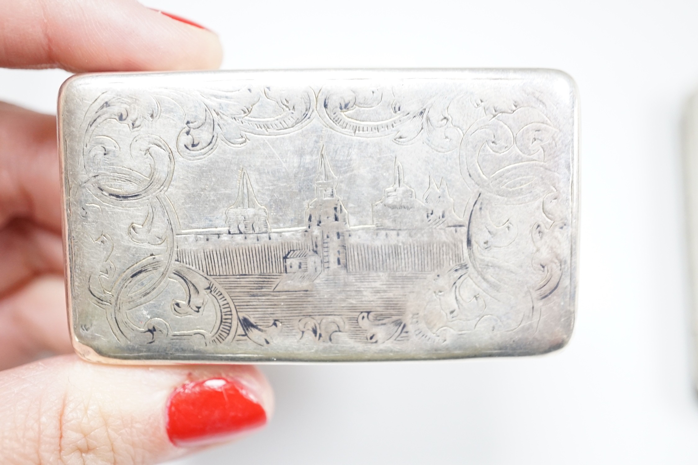 A white metal cigarette case, with applied dragon, 82mm, one other silver cigarette case and a Russian 84 zolotnik snuff box(tired).